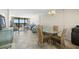 Living and dining areas with comfortable seating, a glass table and balcony access with great views at 9415 Blind Pass Rd # 704, St Pete Beach, FL 33706