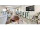 Open living area with TV, comfortable seating and a bar-height counter that opens to the kitchen at 9415 Blind Pass Rd # 704, St Pete Beach, FL 33706