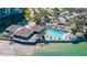 Community center and pool overlooking the water, featuring lounge areas and inviting amenities at 9415 Blind Pass Rd # 704, St Pete Beach, FL 33706