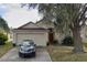 Charming single-Gathering home featuring an attached two-car garage and a mature landscaped yard at 29434 Tansy Pass, Wesley Chapel, FL 33543