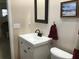 Bright bathroom with a white vanity, modern fixtures, and a framed mirror adding a touch of elegance at 1002 Pussywillow Ln, Bradenton, FL 34208