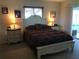 Comfortable bedroom with carpet, side tables, and sliding glass doors to a sunroom at 1002 Pussywillow Ln, Bradenton, FL 34208