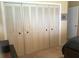 Bedroom featuring large closet space with louvered doors, offering ample storage solutions at 1002 Pussywillow Ln, Bradenton, FL 34208