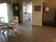 Open dining area with a round table, tile flooring, and view into the kitchen area at 1002 Pussywillow Ln, Bradenton, FL 34208