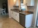 Bright kitchen with granite counters, stainless steel dishwasher, and tile flooring at 1002 Pussywillow Ln, Bradenton, FL 34208