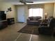 Inviting living room with comfortable seating, neutral tones, and a ceiling fan for added comfort at 1002 Pussywillow Ln, Bradenton, FL 34208