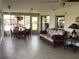 Inviting sunroom with tile floor, wicker furniture, and serene views of the water at 1002 Pussywillow Ln, Bradenton, FL 34208