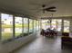 Relaxing sunroom featuring tile floors, lots of light, and scenic views of the community at 1002 Pussywillow Ln, Bradenton, FL 34208