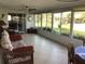 Bright sunroom featuring tile flooring, wicker furniture and large windows to the backyard at 1002 Pussywillow Ln, Bradenton, FL 34208
