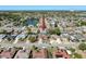 The home's location near a lake with surrounding neighborhood are shown in this aerial view at 1102 Springtime Dr, Holiday, FL 34691