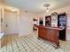 Cozy bar area with tile floors and a decorative liquor cabinet and shelving at 1102 Springtime Dr, Holiday, FL 34691