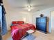 Cozy bedroom with ceiling fan, large bed, and dark wood furnishings at 1102 Springtime Dr, Holiday, FL 34691