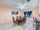 Inviting dining room featuring tile floors, a ceiling fan, and seating for six at 1102 Springtime Dr, Holiday, FL 34691