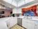 Bright kitchen boasts stone backsplash, white countertops, and modern appliances at 1102 Springtime Dr, Holiday, FL 34691