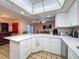 Open concept kitchen with white countertops, appliances, and lots of counter space at 1102 Springtime Dr, Holiday, FL 34691