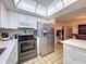 Stainless steel appliances, stone backsplash and white cabinets fill this lovely kitchen at 1102 Springtime Dr, Holiday, FL 34691