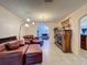 Open living room with decorative fireplace, tile flooring, and comfortable leather furniture at 1102 Springtime Dr, Holiday, FL 34691