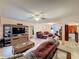 Bright living room featuring tile floors, ceiling fan and comfortable seating with an open floorplan at 1102 Springtime Dr, Holiday, FL 34691