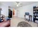 Versatile office space featuring tile flooring, a ceiling fan, and adjacent access to other rooms at 1102 Springtime Dr, Holiday, FL 34691