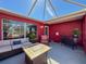 A beautiful enclosed patio featuring a seating area and an outdoor grill at 1102 Springtime Dr, Holiday, FL 34691
