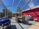 Enclosed patio with outdoor dining set and grill at 1102 Springtime Dr, Holiday, FL 34691