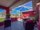 Enclosed patio with outdoor seating, bright light, and access to the backyard at 1102 Springtime Dr, Holiday, FL 34691