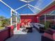 Enclosed patio with comfortable seating, outdoor lighting, and bright natural light at 1102 Springtime Dr, Holiday, FL 34691