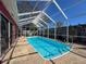 Refreshing pool within a screened enclosure, ideal for relaxation and recreation at 1102 Springtime Dr, Holiday, FL 34691