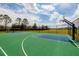 Outdoor basketball court with green surface, chain-link fence, and lakeside views at 11335 77Th E St, Parrish, FL 34219