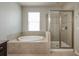 Bright bathroom featuring a soaking tub and a glass-enclosed shower at 11335 77Th E St, Parrish, FL 34219