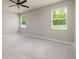 Comfortable bedroom with carpet flooring, two windows, and a ceiling fan at 11335 77Th E St, Parrish, FL 34219