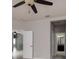 Bedroom featuring a ceiling fan, grey walls, and view to a bathroom at 11335 77Th E St, Parrish, FL 34219