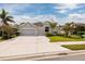 Inviting single-story home with a spacious driveway, a two-car garage, and lush green landscaping at 11335 77Th E St, Parrish, FL 34219