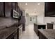 Modern kitchen with stainless steel appliances, granite countertops, and dark wood cabinetry at 11335 77Th E St, Parrish, FL 34219