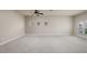 Expansive living room featuring plush carpeting, neutral paint, and multiple windows offering ample natural light at 11335 77Th E St, Parrish, FL 34219