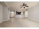 Open-concept living room with tile flooring, ceiling fan, and view of the modern kitchen at 11335 77Th E St, Parrish, FL 34219