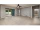 Spacious living room with tile flooring, sliding glass doors, and access to the backyard at 11335 77Th E St, Parrish, FL 34219