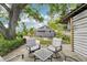 Backyard patio featuring a bar structure and outdoor seating amidst lush greenery at 114 E Emily St, Tampa, FL 33603