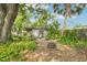 Lush backyard featuring a fire pit and an outdoor bar, great for entertaining at 114 E Emily St, Tampa, FL 33603