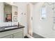 Bright bathroom featuring white subway tiles, a rainfall shower head, and a modern vanity at 114 E Emily St, Tampa, FL 33603