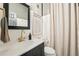 This bathroom has a black vanity with a gold faucet and a mirror hanging above the sink at 114 E Emily St, Tampa, FL 33603