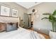 This bedroom has wood floors, natural-colored walls, and a bed with grey, white, and brown striped bedding at 114 E Emily St, Tampa, FL 33603