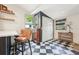 Stylish dining area with black and white checkered flooring, complemented by a cabinet and windows at 114 E Emily St, Tampa, FL 33603