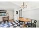 Charming dining area featuring a wooden table, black chairs, and a unique checkered floor at 114 E Emily St, Tampa, FL 33603