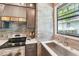 The kitchen has stainless steel appliances, wooden cabinetry, and a window with a vintage pane above the sink at 114 E Emily St, Tampa, FL 33603