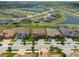 Community aerial view showcasing a well-maintained neighborhood, with a lake and tree lined streets at 11966 Climbing Fern Ave, Riverview, FL 33579