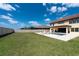 Large backyard with a pool, patio, and green lawn, enclosed by a white privacy fence at 11966 Climbing Fern Ave, Riverview, FL 33579