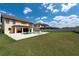 Spacious backyard with a pool, lush lawn, and beautiful landscaping, perfect for outdoor enjoyment at 11966 Climbing Fern Ave, Riverview, FL 33579
