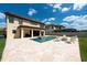 Gorgeous backyard pool with travertine deck, a built-in spa, and comfortable outdoor furniture at 11966 Climbing Fern Ave, Riverview, FL 33579