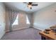 Bedroom featuring plush carpeting, ceiling fan, and curtains over the windows at 11966 Climbing Fern Ave, Riverview, FL 33579